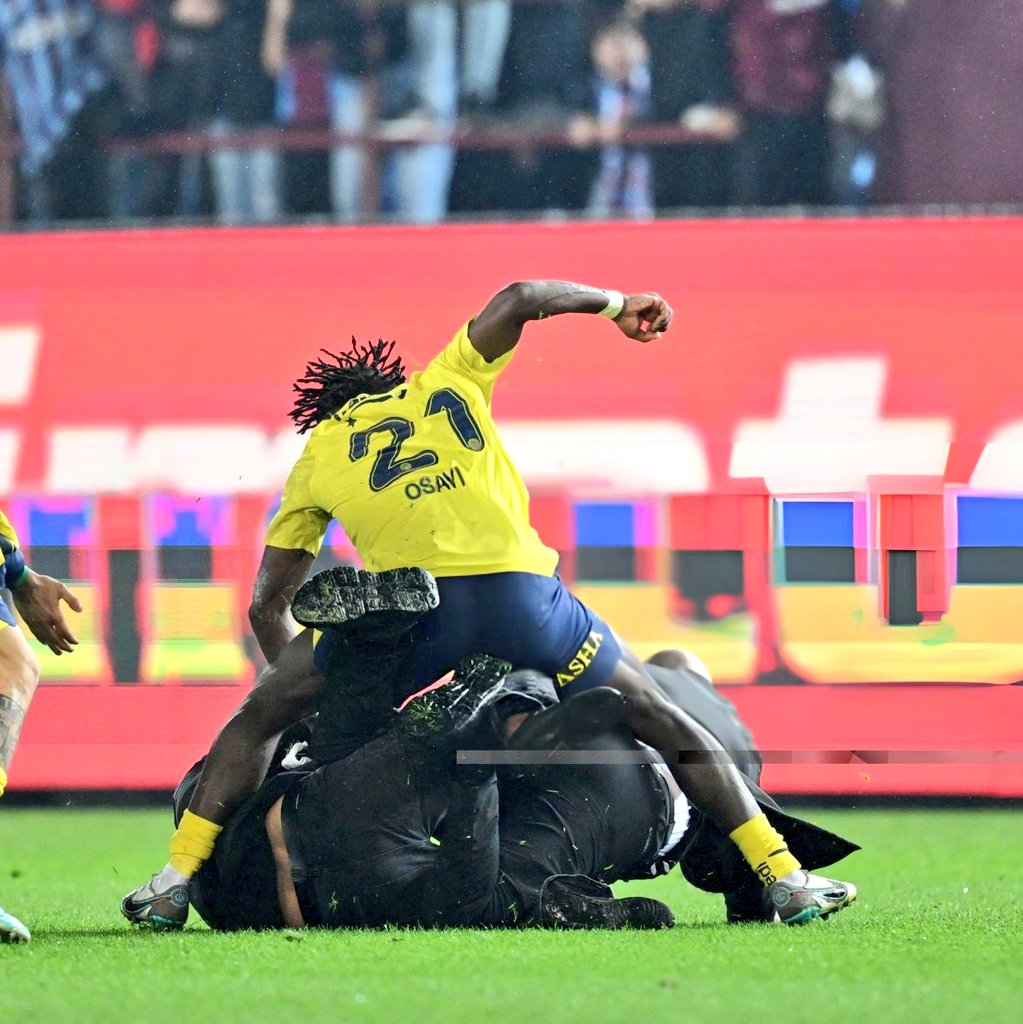 Super Eagles Bright Osayi Samuel of the Fenerbahce’s defends himself and Teammates from Field Invader